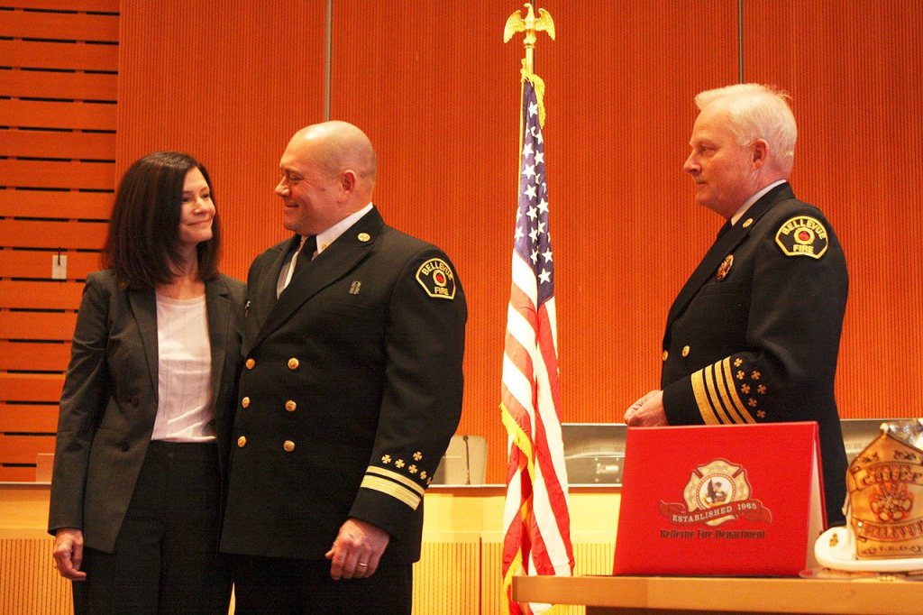 Newly promoted Deputy Chief Todd Dickerboom, center, stands with his wife Tracie as Chief Mark Risen prepares to promote him (Allison DeAngelis/staff photo).