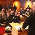 Newly promoted Deputy Chief Todd Dickerboom, Battalion Chief Keith Allen and Lieutenant Luke Steere listen to Fire Chief Mark Risen during their promotion ceremony on Dec. 2 (Allison DeAngelis/staff photo).