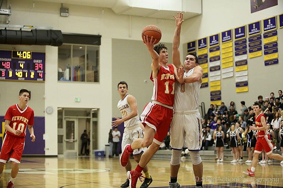 Photo courtesy of Don Borin/Stop Action Photography                                Newport forward Matt McCord, left, takes the ball to the hoop while being guarded by Issaquah&rsquo;s Tanner Davis. McCord scored 12 points for the Knights but the Eagles held on for a 58-45 victory on Jan. 13 at Issaquah High School.