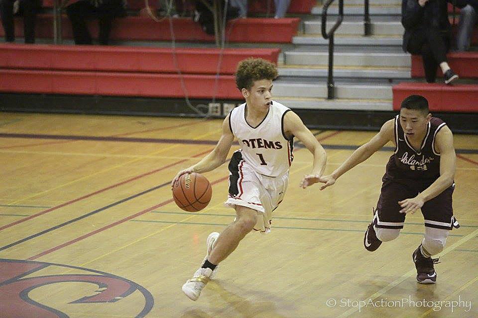 Photo courtesy of Don Borin/Stop Action Photography                                Sammamish Totems guard John Kibby, left, makes a move to the basket against Mercer Island defender William Lee, right, in a contest on Jan. 10 at Sammamish High School. Mercer Island defeated Sammamish 75-48.
