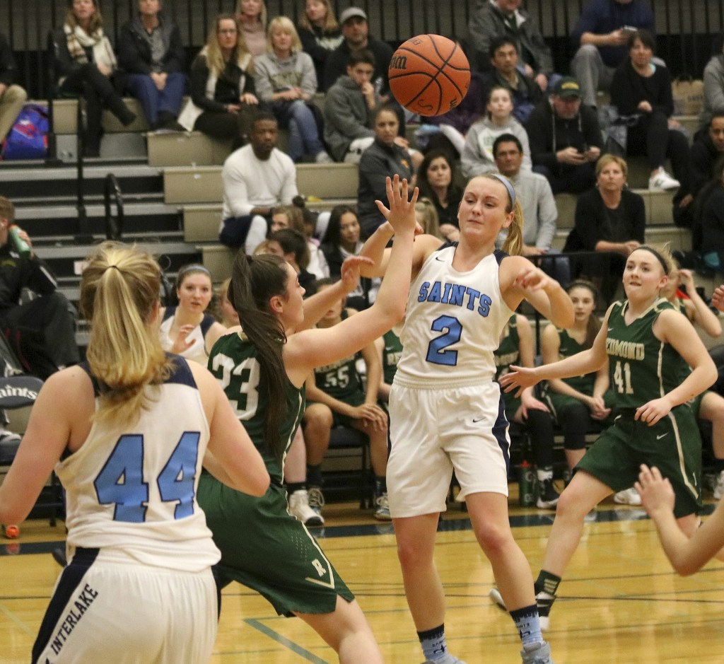 Photo courtesy of Andy Nystrom                                The Redmond Mustangs girls basketball team defeated the Interlake Saints 58-44 in a showdown between KingCo 3A teams on Jan. 30. Interlake senior guard Amanda Mehlhoff, center, makes a pass to a teammate while being guarded by Redmond junior forward Teagyn Ohrt. Redmond improved their overall record to 12-8 with the win while Interlake dropped to 5-14.