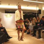 A model poses at the end of the runway at Neiman Marcus&rsquo; Spring Fashion Runway Show while wearing a multicolor printed dress (Allison DeAngelis/staff photo).