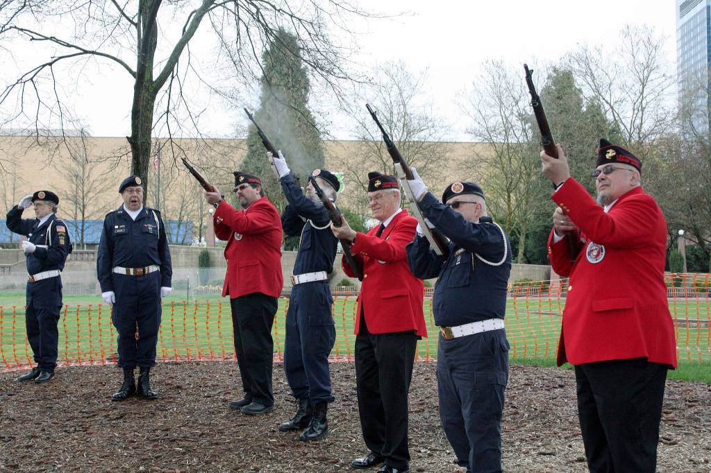 Veterans and Leathernecks forming an honor guard fire rifles in honor of Clarence Oscar Johnson, Victor Hanson and Victor Freed. The three lost their lives in the First World War.