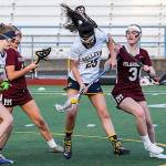 Photo courtesy of Rick Edelman/Rick Edelman Photography                                Bellevue Wolverines girls lacrosse player Alexis Huynh, center, battles with Mercer Island players for posssession of the ball. Mercer Island defeated Bellevue 17-3 on April 20 at Bellevue Memorial Stadium in Bellevue.