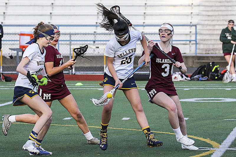 Photo courtesy of Rick Edelman/Rick Edelman Photography                                Bellevue Wolverines girls lacrosse player Alexis Huynh, center, battles with Mercer Island players for posssession of the ball. Mercer Island defeated Bellevue 17-3 on April 20 at Bellevue Memorial Stadium in Bellevue.