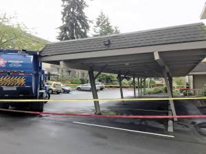 Bellevue Fire Department evacuates apartment after garbage truck damages carport