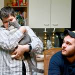 Maslan nuzzles Diesel the cat as her nephew Adam looks on. Photo courtesy of Regina Friedland