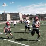 Shaun Scott, staff photo                                Newport Knights running back Justin Baker, right, turns up the field after catching a pass in the flat during the third day of spring football practice on June 16 at Newport High School in Factoria.