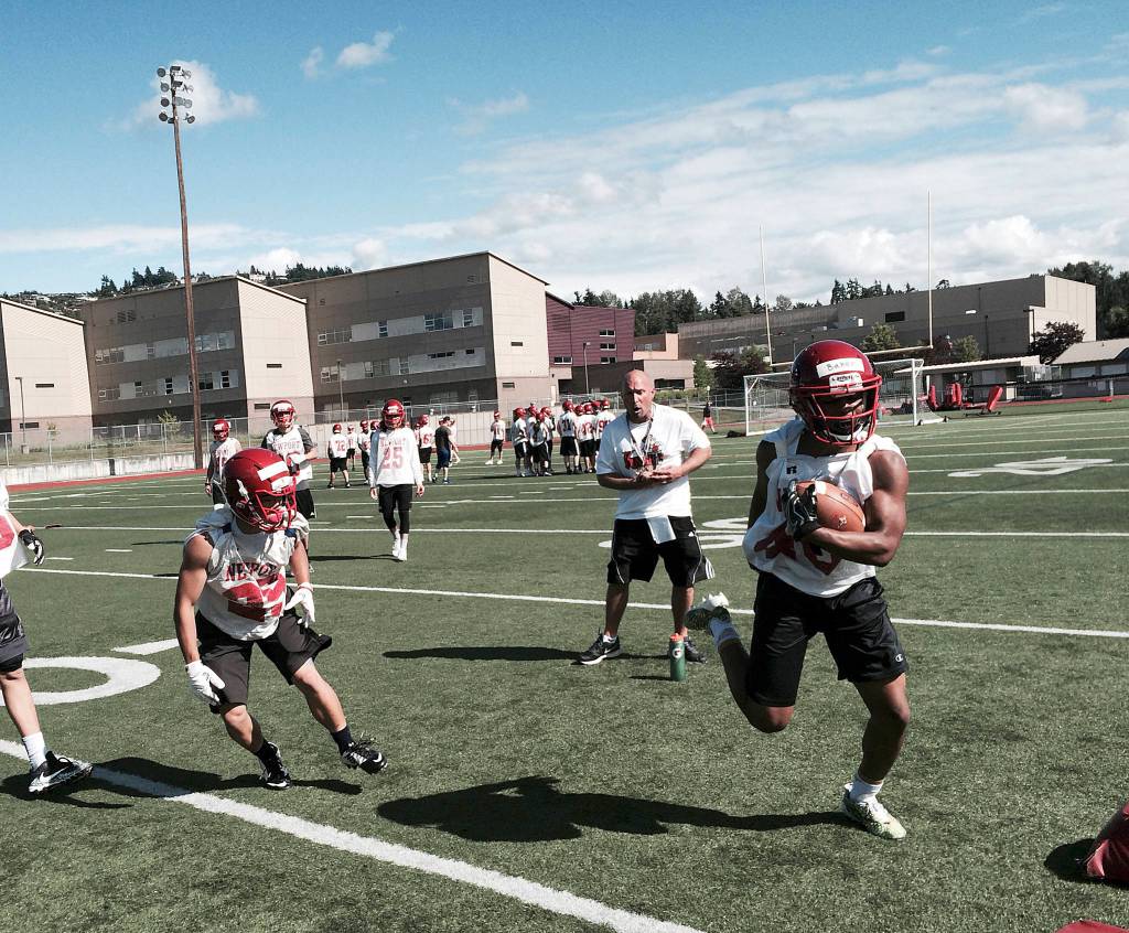 Shaun Scott, staff photo                                Newport Knights running back Justin Baker, right, turns up the field after catching a pass in the flat during the third day of spring football practice on June 16 at Newport High School in Factoria.
