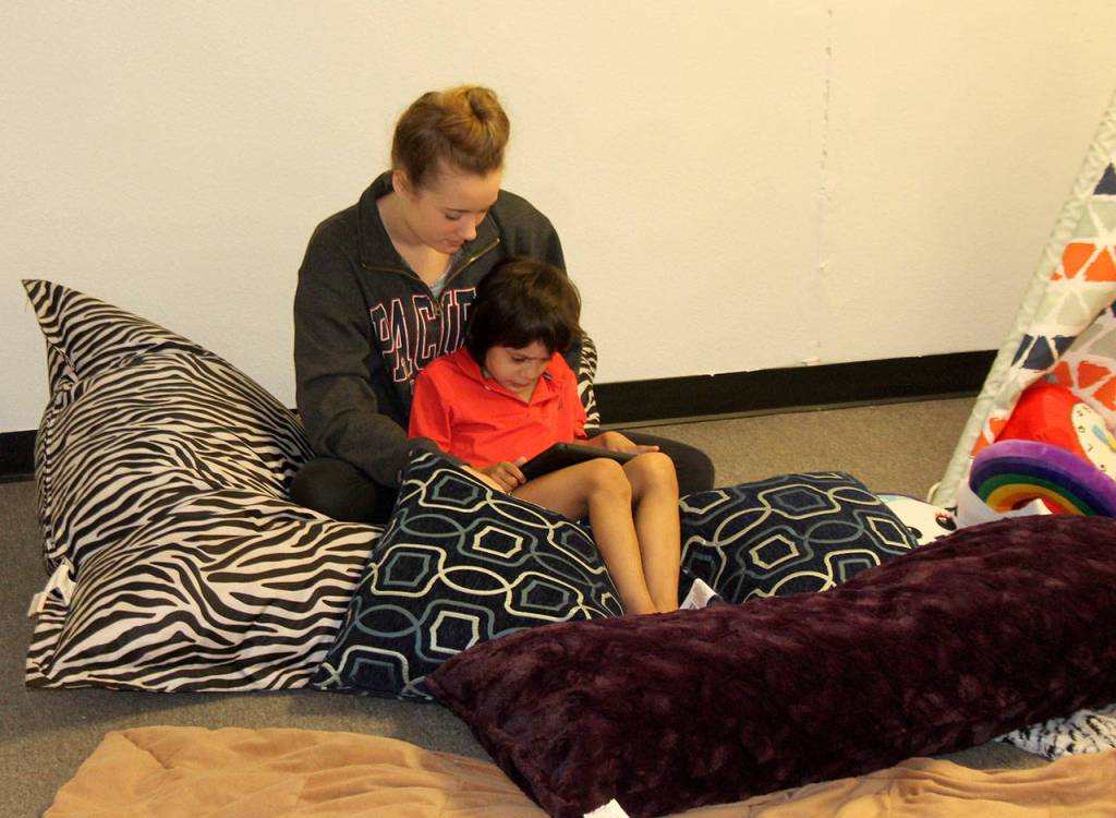An employee reads Sarmiento-Blaha&rsquo;s son a story to calm him down from his &ldquo;meltdown.&rdquo; Raechel Dawson/staff photo