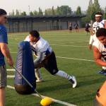 Shaun Scott/staff photo                                Eastside Bulldogs defensive lineman, James Taupule right, explodes out of his stance while Bulldogs&rsquo; head coach Kevin Bouwman, left, shouts words of encouragement.