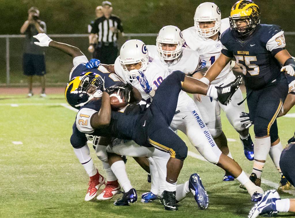File photo                                A Bellevue Wolverines running back gets tackled during the season opener in 2015 against Bishop Gorman (Las Vegas) in a non-league contest.