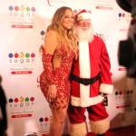 Singer Mariah Carey poses with Santa Claus on the red carpet of Bellevue&rsquo;s new Sugar Factory American Brasserie Wednesday night. Raechel Dawson/staff photo