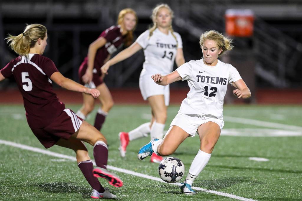 Photo courtesy of Rick Edelman/Rick Edelman Photography                                 Sammamish Totems soccer player Colette Liston, right, tries to manuever around Mercer Island forward Nicole Mandt in a game on Sept. 14 in Bellevue. Mercer Island defeated Sammamish 3-0.