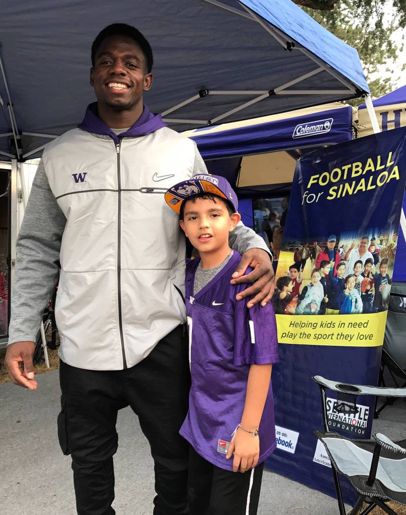 Photo courtesy of Bryan Tomlinson                                Football for Sinaloa, which is a Bellevue-based organization, put together a memorable weekend for Angel Uribe Paez from Sept. 15 through Sept. 17. Paez, who is a nine-year-old quarterback for the Culiacan Rhinos football team in Mexico, won Football for Sinaloa&rsquo;s 2017 Student Athlete of the Year Award. Paez currently carries a 9.7 GPA (out of 10) and is described by teachers and coaches as a true leader in the classroom and on the field. Paez spent three days in the Seattle region meeting NFL/NCAA football players, attending football games as well as receiving specialized football training. Paez had field passes to the University of Washington Huskies football game against Fresno State on Sept. 16 and had field passes to the Seattle Seahawks football game against the San Francisco 49ers on Sept. 17. The 9-year old signal caller also took part in specialized quarterback drills/training sessions at the Pro Sports Club in Bellevue as well as at the Ford Sports Performance facility in Bellevue. Angel Uribe Paez, right, is pictured with former Huskies football player Deontae Cooper, left, on Sept. 16.