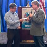 Dave Lenox, the CEO of Special Olympics Washington accepts a $5,000 donation from Kaj Pedersen, the president of the Bellevue Breakfast Rotary Club. Photo courtesy of the Bellevue Breakfast Rotary Club