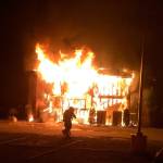 A firefighter stands in front of the Jan. 14 blaze that has significantly damaged the Islamic Center of the Eastside. Photo courtesy of the Bellevue Fire Department