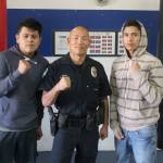 Carlos Enrique Herrera, Bellevue police officer Craig Hanaumi and Facundo Salinas at Ring Sports United. Jon Ladd/ Reporter intern