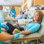 Woman donating blood in busy donation center. Courtesy photo