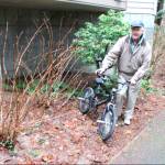 Police volunteer Don Erickson retrieves an abandoned bicycle. Next stop: the police evidence room, and possibly Africa. Photo courtesy of the Bellevue Police Department
