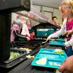 Students at Stevens Elementary in Spokane put food on their trays. Photo courtesy of the state Legislature