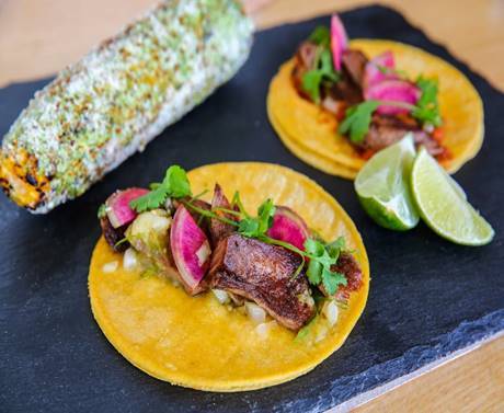 Barrio Luchador: Honoring Mexicos al pastor tacos & other street food favorites from a brash Airstream trailer Highlights: Street tacos: al pastor featuring LanRoc Farms pork, St. Helens beef tongue, Pollo Adobo, Carne Asada with steak from Snake River Farms, Cabeza- Beef Cheek, Vegetarian- mushroom mole| White corn and flour tortillas from La Mexicana in White Center | House-made salsas| House-made mole using Theos unsweetened chocolate