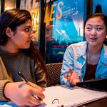 Newport High School junior Sachi Madan (left) and sophomore Rosie Huang (right) discuss the next phase of their mental health awareness project after school on Jan. 16. Photo courtesy of Sarah Corn/UW News Lab