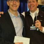 Adam Mihlstin, the Bellevue Breakfast Rotary Clubs community and vocational services chair, hands a check to David Bobanick, executive director for Rotary First Harvest. Photo courtesy of Kaj Pedersen/Bellevue Rotary