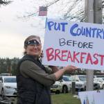 Ellen Lackermann waves her sign to some of the cars passing by. Evan Pappas/Staff Photo