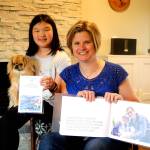 Megan, 11, with her dog Penny and mother Jenny Lisk in their Redmond home. Megan holds a stack of her cards while her mother holds a book featuring Megan with Dr. Charles Cobbs, the neurosurgeon who operated on her father. Raechel Dawson/staff photo