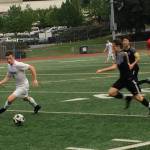 Shaun Scott, staff photo                                Interlake Saints midfielder James Sullivan, left, tries to get to the ball before a Lake Washington player in the first half of a loser-out, KingCo 3A playoff game. Interlake defeated Lake Washington 4-1 on May 8 at Interlake High School in Bellevue.