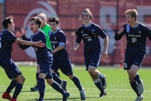 Photo courtesy of Rick Edelman/Rick Edelman Photography                                Interlake Saints players mob Nainoa Loschky (No. 6) after he scored the first goal of the game in the 35th minute of play. Interlake defeated the ODea Fighting Irish 3-1 in a winner-to-state, loser-out KingCo 3A playoff matchup on May 12 at Interbay Stadium in Seattle.