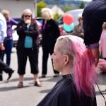 Right: A close-up of Erin Hansman getting her head shaved. Hansman is a senior analyst of customer experience at SAP Concur. Photo courtesy of Eastside Baby Corner