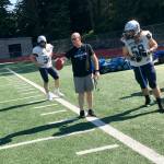 Interlake Saints head football coach Shawn Hartline, center, makes a point to one of his players during a spring practice session on June 19 at Interlake High School in Bellevue. Hartline, who will be in his first season as head coach of the Saints this fall, was an assistant on the Saints staff during the 2016 and 2017 seasons. Shaun Scott, staff photo