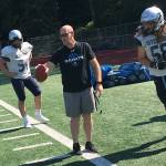 Interlake Saints head football coach Shawn Hartline, center, makes a point to one of his players during a spring practice session on June 19 at Interlake High School in Bellevue. Hartline, who will be in his first season as head coach of the Saints this fall, was an assistant on the Saints staff during the 2016 and 2017 seasons. Shaun Scott, staff photo