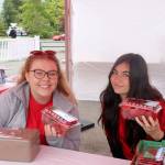 Lindsay McNally, Interlake High School, and Alohi Holing, Sammamish High School, volunteer at the strawberry booth selling fresh strawberries. Evan Pappas/Staff Photo
