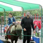 The Ghanaati family takes their daughter for a pony ride at the festival. Evan Pappas/Staff Photo
