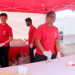 Interlake High School students make and sell the festivals strawberry shortcake treat on Saturday. From left: Hoang Nguyen, Faizan Dhankwain, and Deepnath Dey. Evan Pappas/Staff Photo