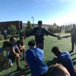 Eastside Bulldogs head coach Kevin Bouwman talks to his team during a practice session on June 26 at Bellevue High School. The Bulldogs, who captured back-to-back Northwest Junior College Football League (NWJCFL) titles in 2015 and 2016, finished with an overall record of 5-4 during the 2017 season.                                Shaun Scott, staff photo