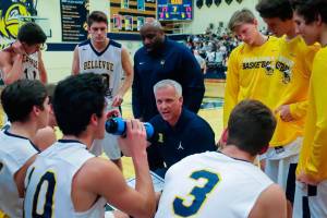 Chris OConnor (center) resigned as head coach of the Bellevue Wolverines boys basketball program in May of 2018. OConnor said he resigned to spend more time with his family. OConnor coached the Wolverines varsity basketball program for 12 seasons.                                Photo courtesy of Don Borin/Stop Action Photography