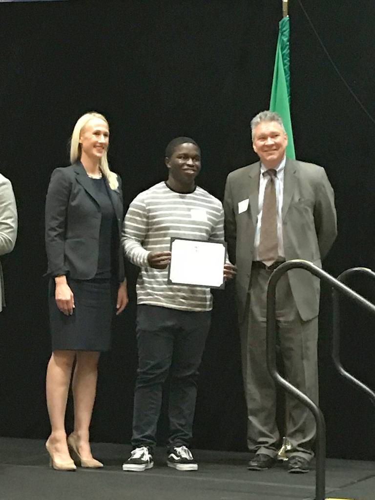 Bellevue High School graduate, DJ Wulah, accepts the Ralph James Family Memorial Scholarship on stage. Wulah plans on attending the University of Redlands to continue his higher education. Hanson Lee/staff photo