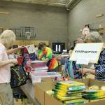 Volunteers pack backpacks according to the students needs. Madison Miller/staff photo.