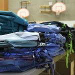 Table of new backpacks waiting to be filled with school supplies. Madison Miller/staff photo.