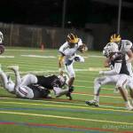 Wolverines quarterback Joey Echigoshima rumbles for yardage against the Mercer Island Islanders in October of 2017. Echigoshima will be in his second season as the starting quarterback this fall. Photo courtesy of Don Borin/Stop Action Photography