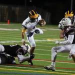 Wolverines quarterback Joey Echigoshima rumbles for yardage against the Mercer Island Islanders in October of 2017. Echigoshima will be in his second season as the starting quarterback this fall. Photo courtesy of Don Borin/Stop Action Photography