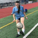 Interlake Saints girls soccer team senior defender Olivia Benson juggles the soccer ball on the sidelines prior to the start of practice on Sept. 12 at Interlake High School in Bellevue. Benson relishes being a senior leader on the soccer pitch for her team. Shaun Scott/staff photo