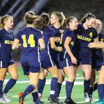 Bellevue players celebrate after scoring a goal against the Lake Washington Kangaroos. Bellevue trailed Lake Washington 2-0 at halftime but scored two goals in the second half to tie the game. After two-five minute overtime sessions, the game ended in a 2-2 draw on Sept. 13 at Bellevue High School. Photo courtesy of Rick Edelman/Rick Edelman Photography