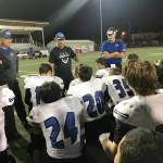 Bellevue Christian Vikings head coach Todd Green, center, addresses his team on the field at Sunset Chev Stadium in Sumner following their 45-7 loss to the Cascade Christian Cougars on Sept. 29. Shaun Scott/staff photo