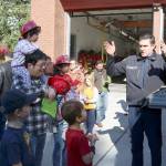 Engineer Firefighter John Harn teaches kids about the various equipment a Fire Engine carries. Evan Pappas/Staff Photo