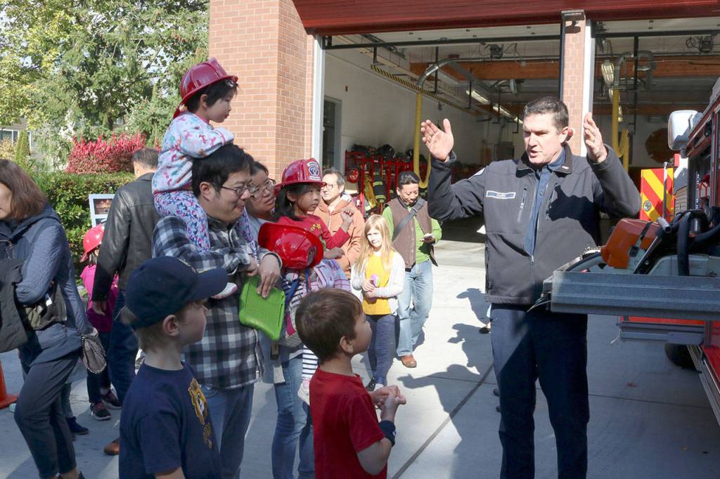 Engineer Firefighter John Harn teaches kids about the various equipment a Fire Engine carries. Evan Pappas/Staff Photo